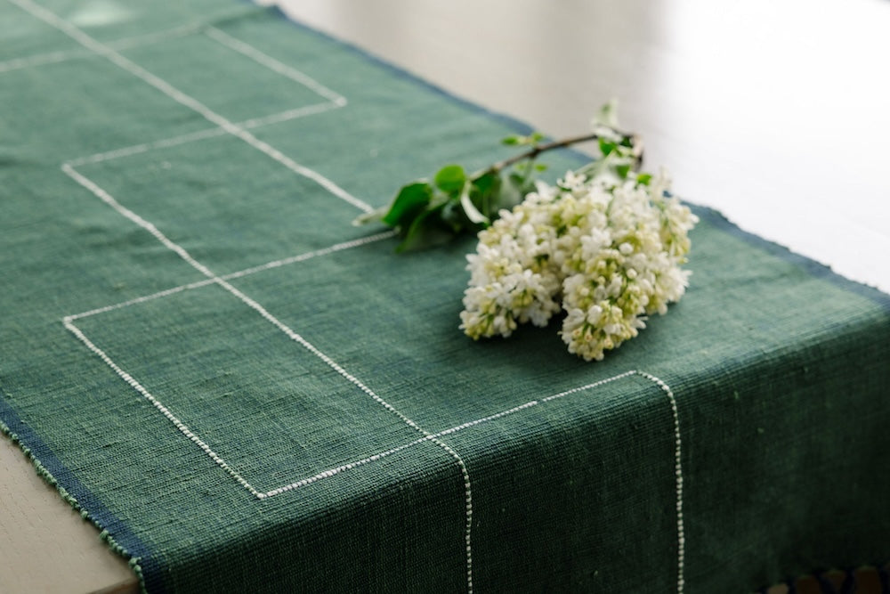 Close up of Rift Valley table runner cedar with a lilac flower