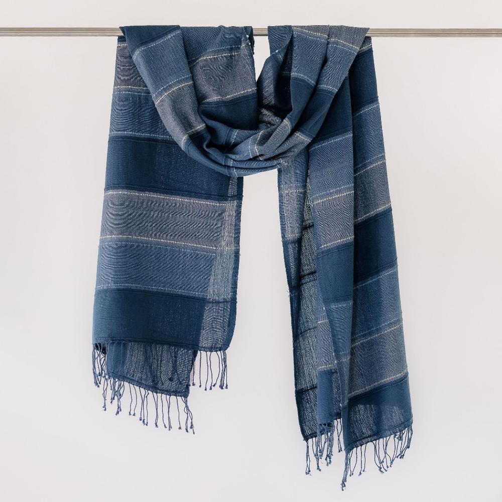 Danakil shawl in navy on a bar.