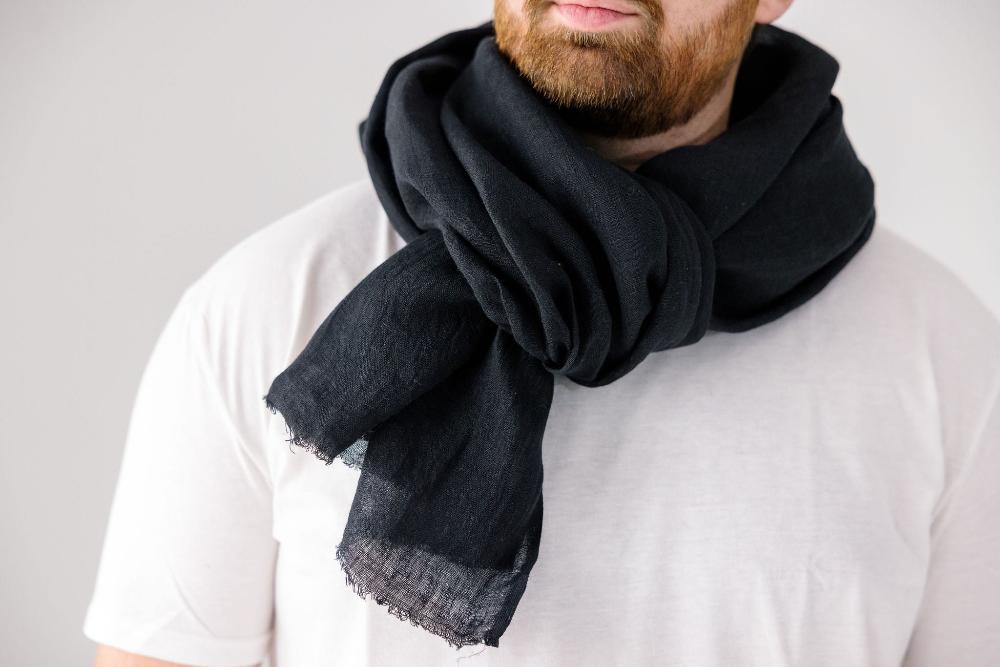 Telba linen shawl in black on a male model.