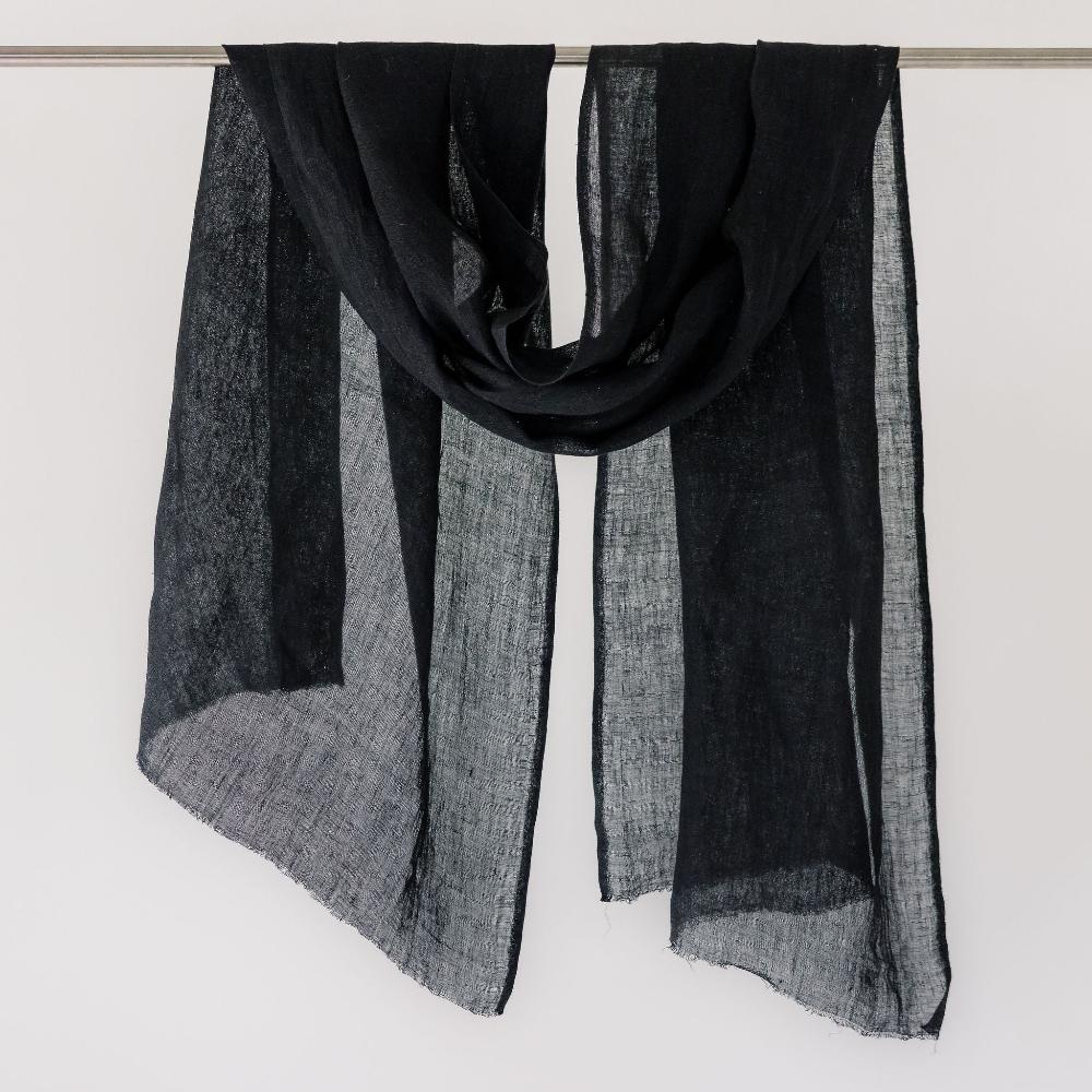 Telba linen shawl in black on a bar