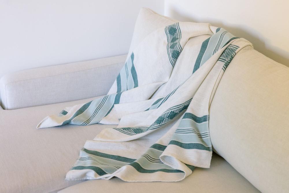 Weyra Towel in azurro and teal on a couch