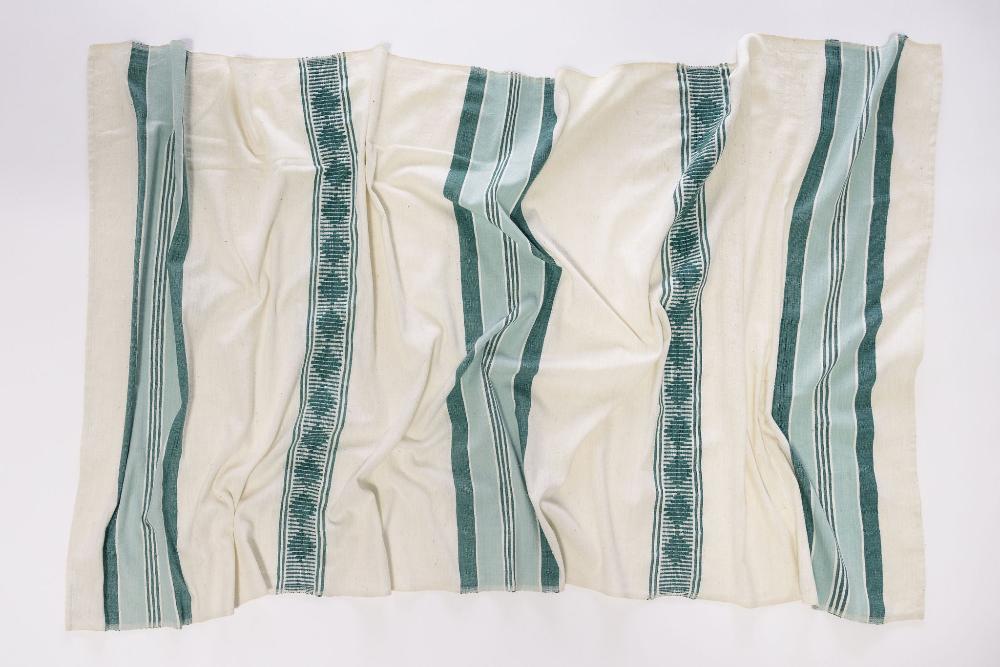 Weyra towel in azurro and teal flat lay on white background