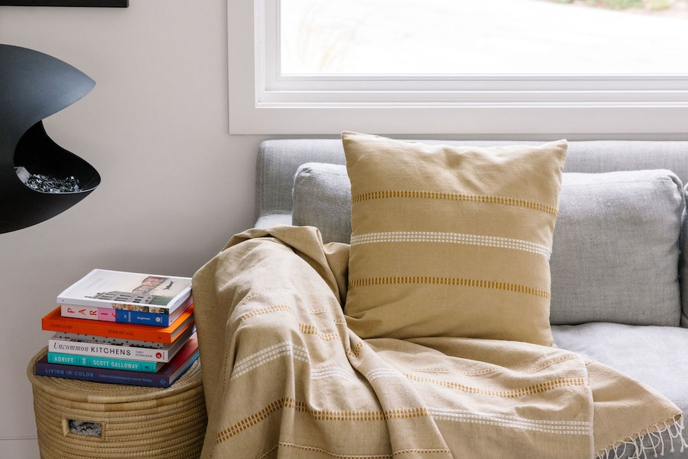 Zenach beige throw and cushion on a couch