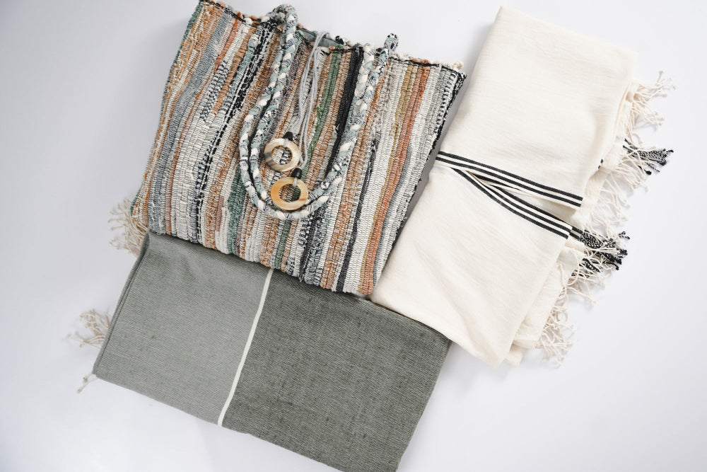 flat lay petra kaftan abay towel and fasika bag