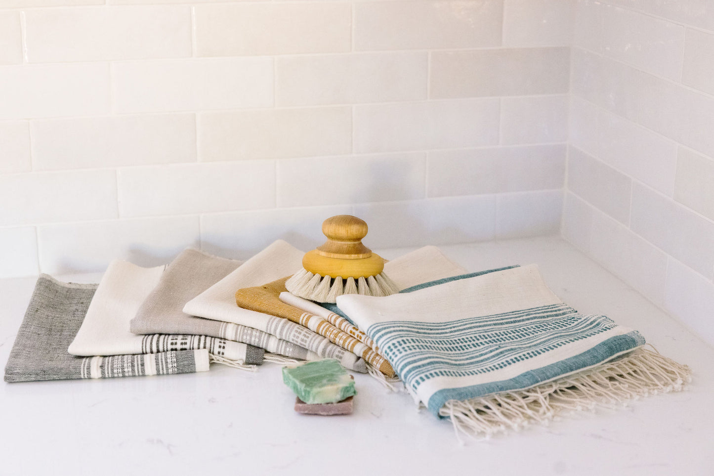 genalé hand towels in all colors pilled up in bathroom