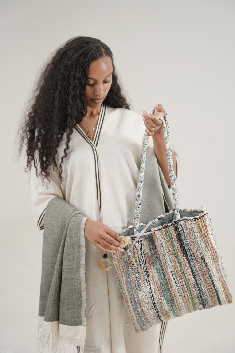 petra kaftan in black on ethiopian model with fasika bag and abay towel