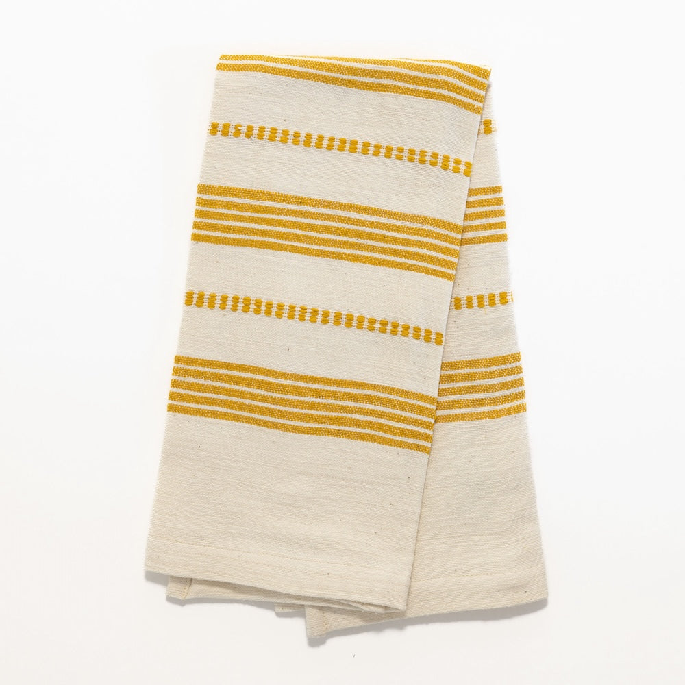 Terrara tea towel in gold folded on white background