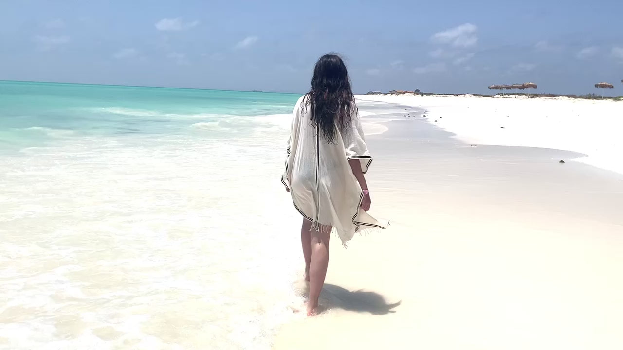Video of model wearing petra kaftan on the beach