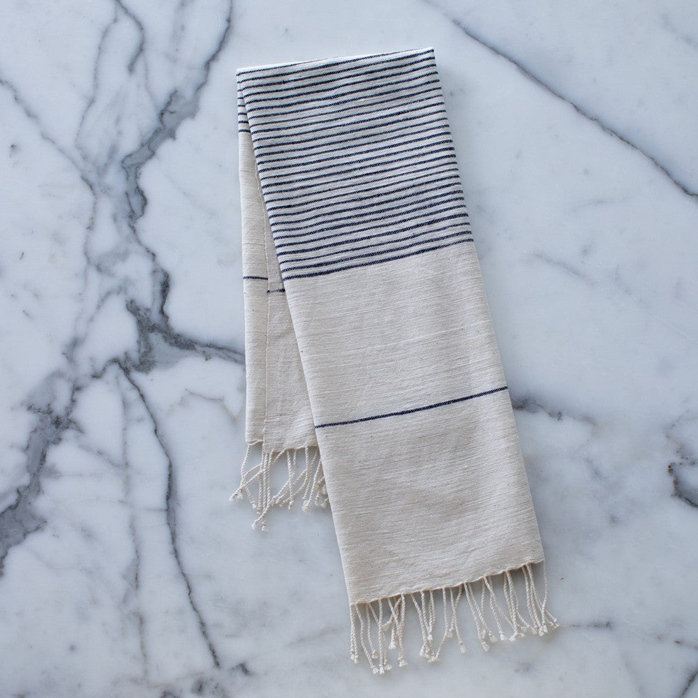 Roha kitchen towel in navy on marble background