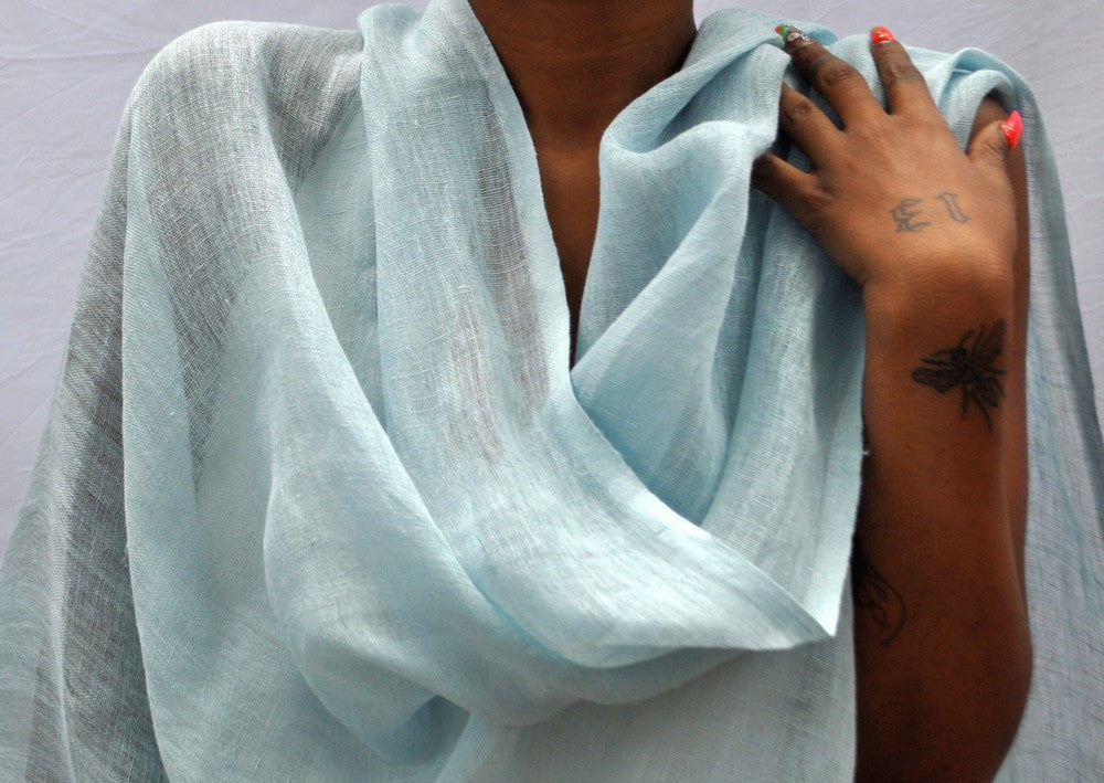 Telba linen shawl in azurro on a model.