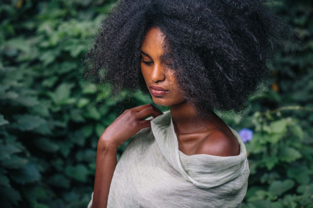 Mariam linen scarf in charchoal wrapped around female model in nature
