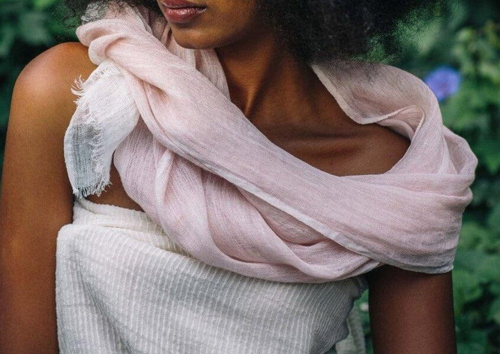 Mariam linen scarf in blush wrapped around female model in nature