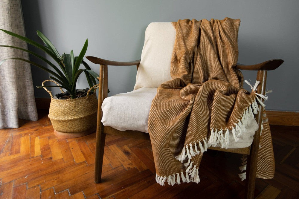 Mechot blanket Throws in bronze on chair in living room