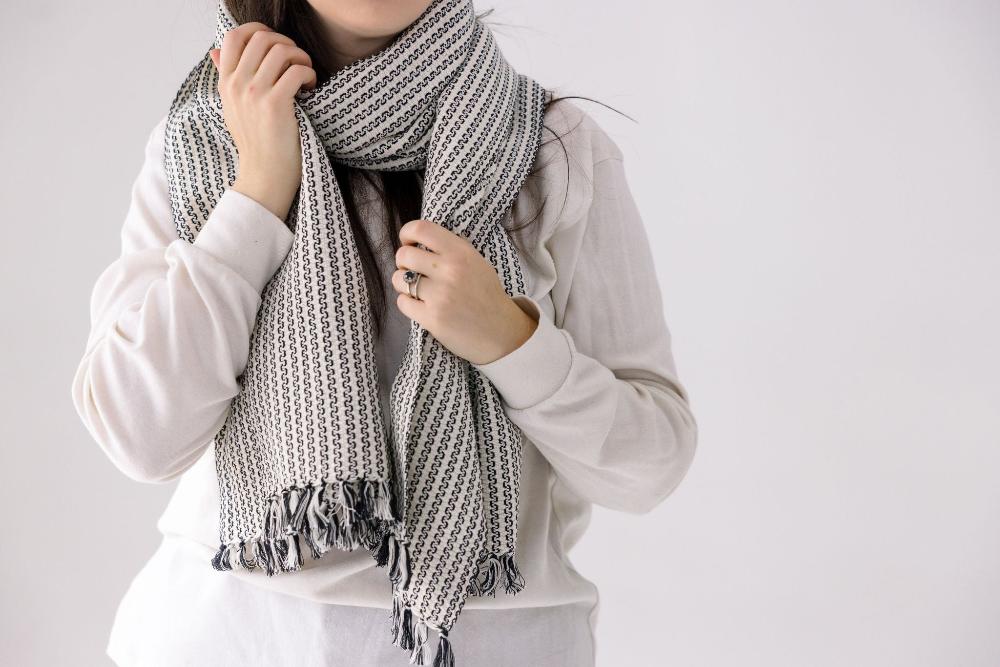 Aaron scarf in ivory and black on a model with white background