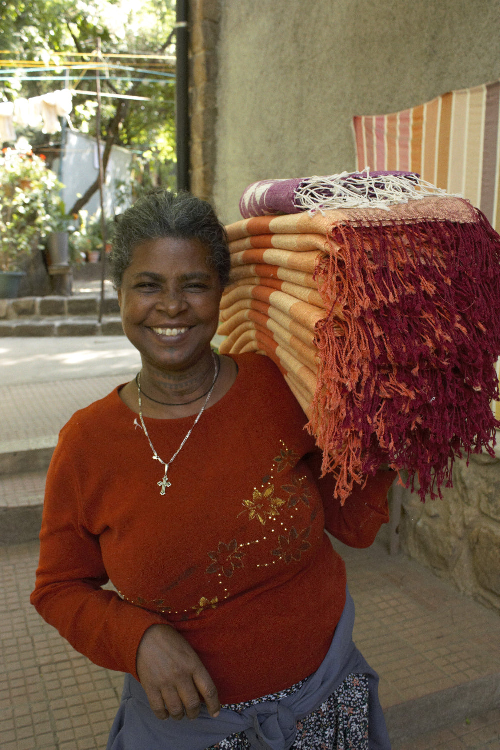 Artisan carrying a bundle of mareb new towels 