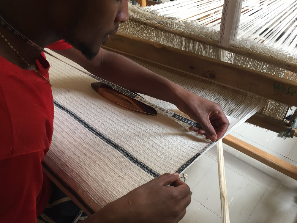 Artisan weaving wari towel on traditional loom