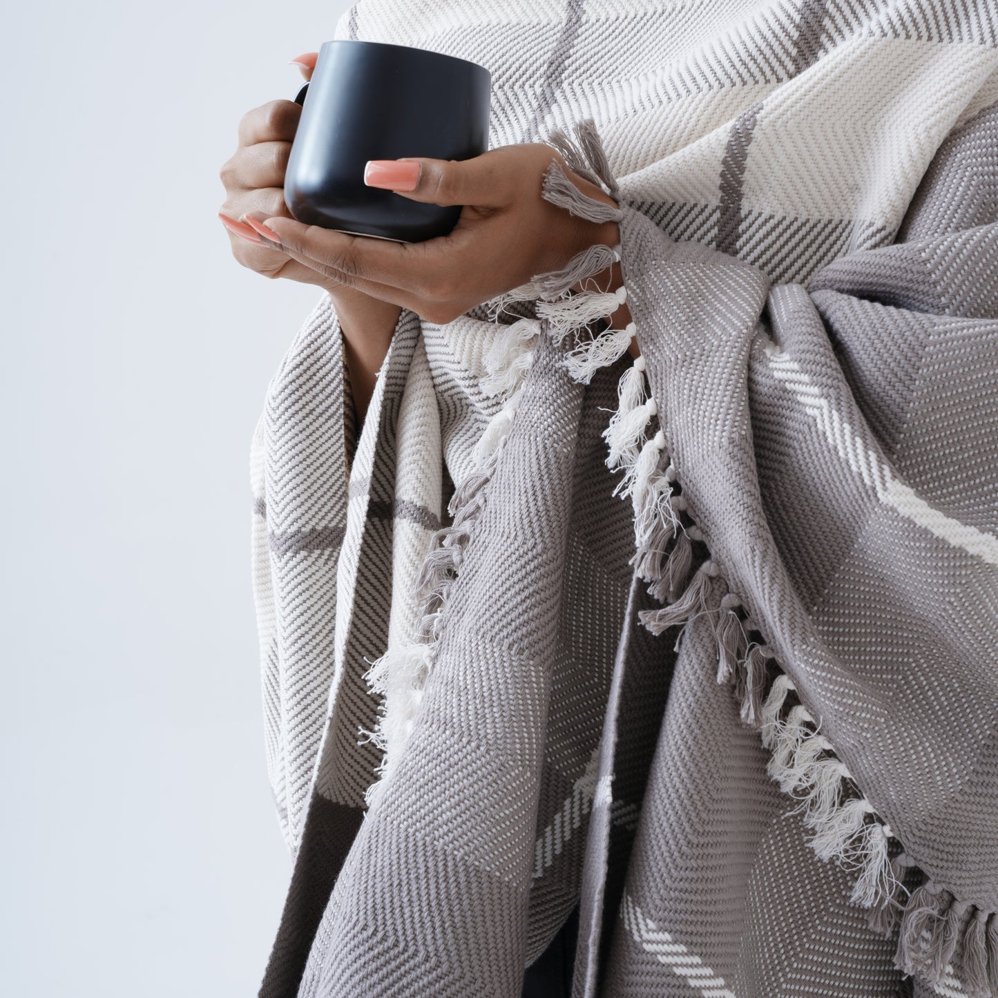 Ayele Throw Blaket Close Up Wrapped Around Model Holding a Mug