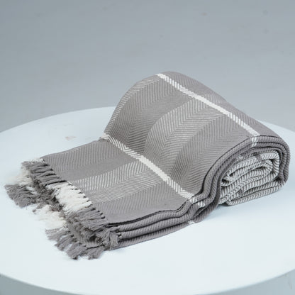 Ayele Throw Blanket Rolled on White platform