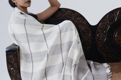 Ayele Throw Blanket Wrapped around Model sitting on a chair