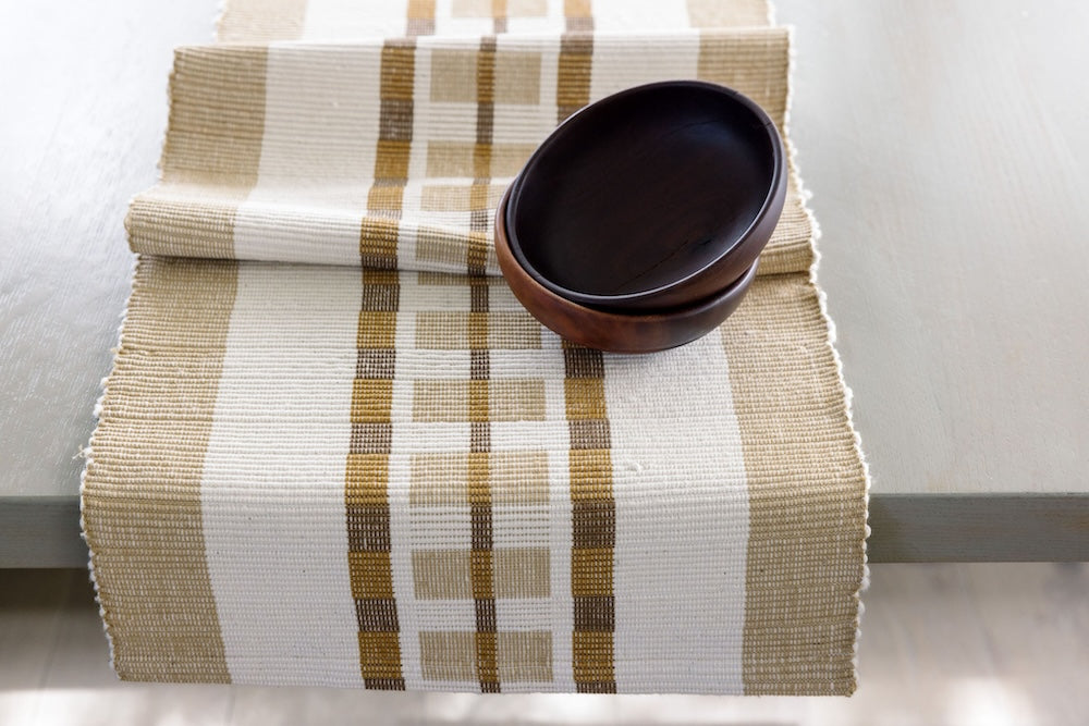 Bronze Gonder table runner with wooden bowls on a table