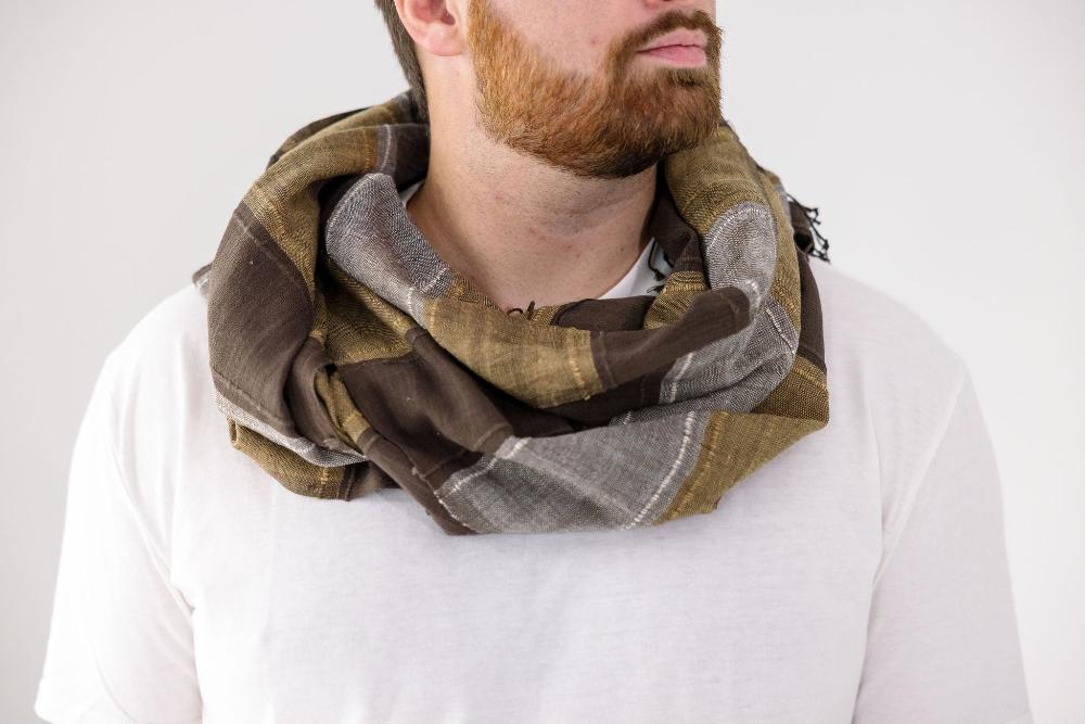 Danakil shawl in cacao wrapped around the neck of male model