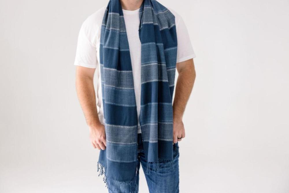 Danakil shawl in navy on male model on white background.