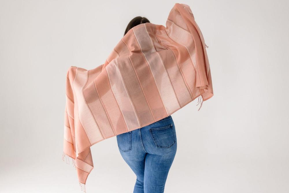 Danakil shawl in blush on a model from the back on white background. 