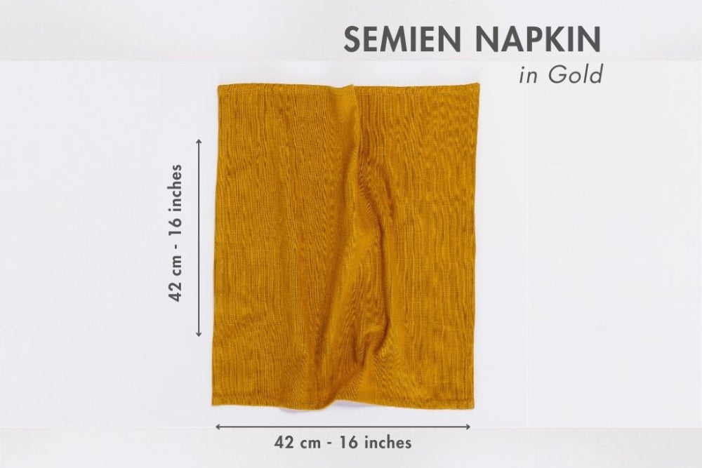 Gold semien napkin with dimensions on a white background