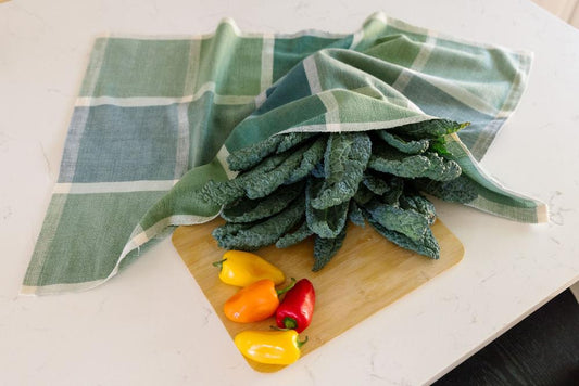 Jane kitchen towel in flax with cutting board and vegetables