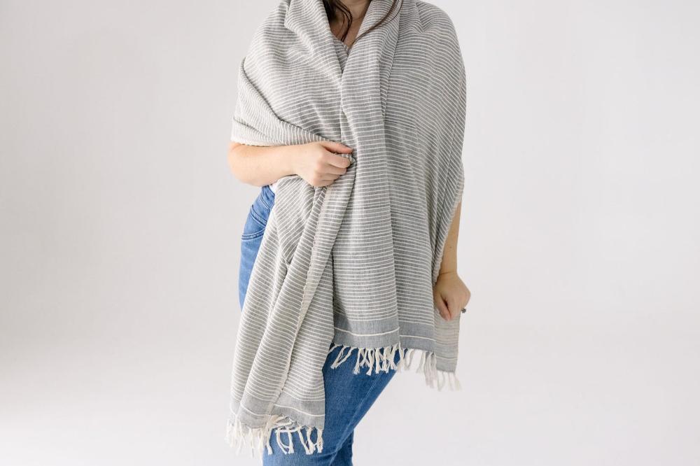 Female model wearing a Judith shawl in grey