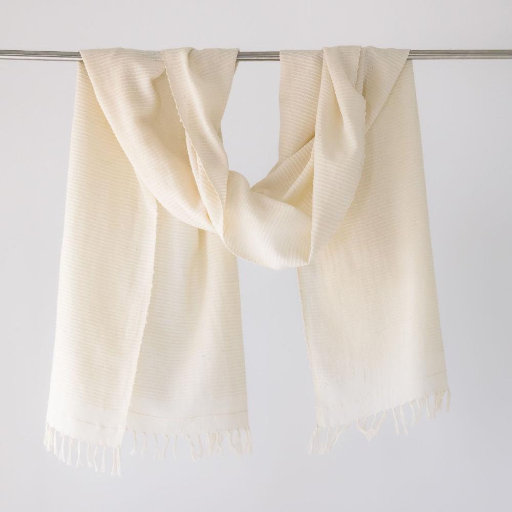 Judith shawl in ivory hanging on a bar