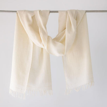 Judith shawl in ivory hanging on a bar