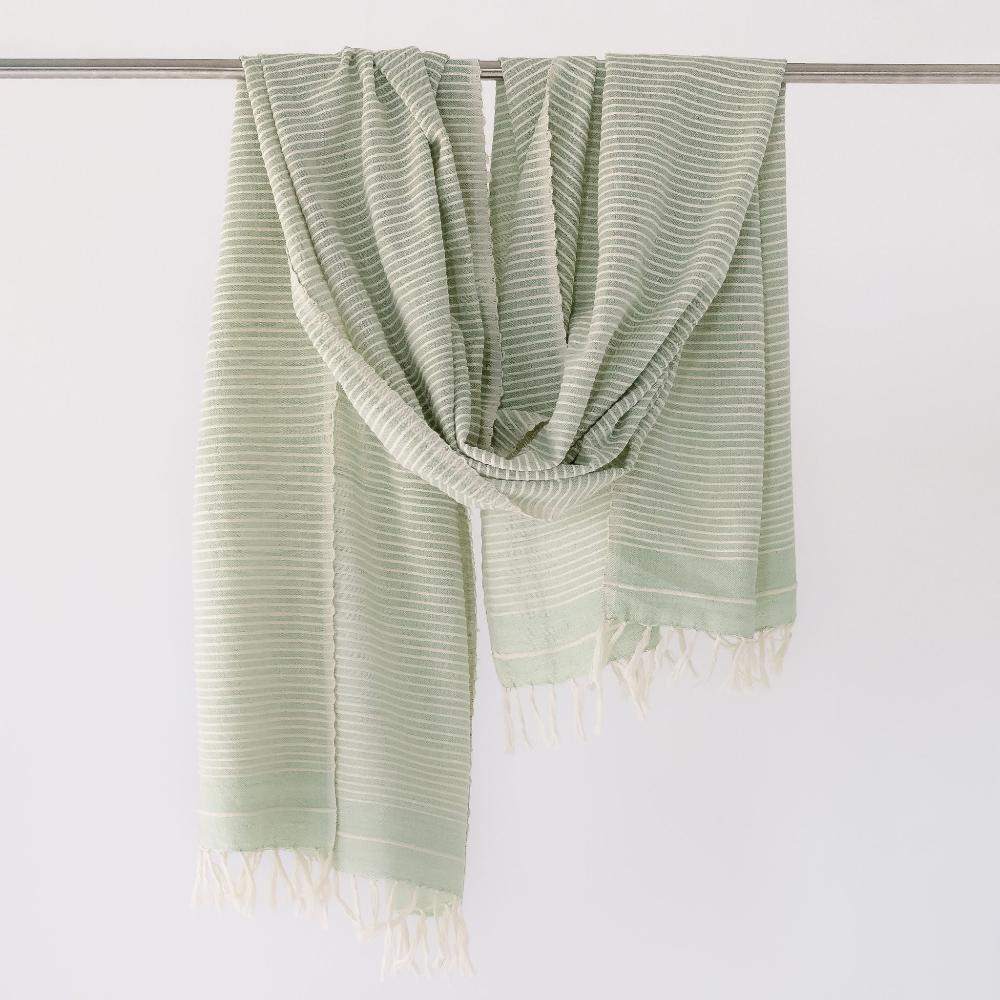 Judith shawl in mint hanging on a bar