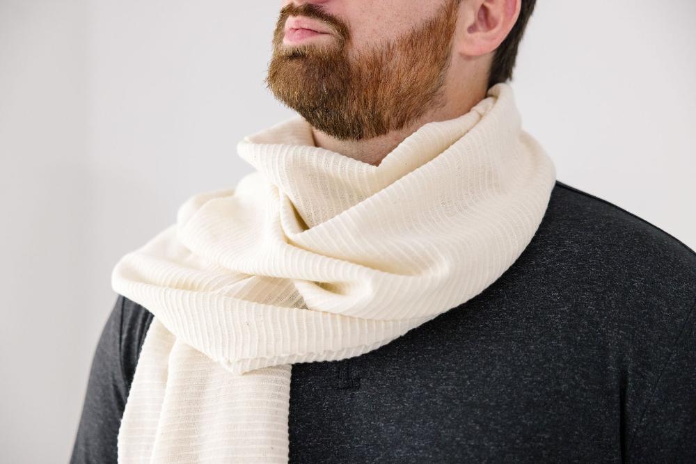 Ivory shawl wrapped around neck of man with beard