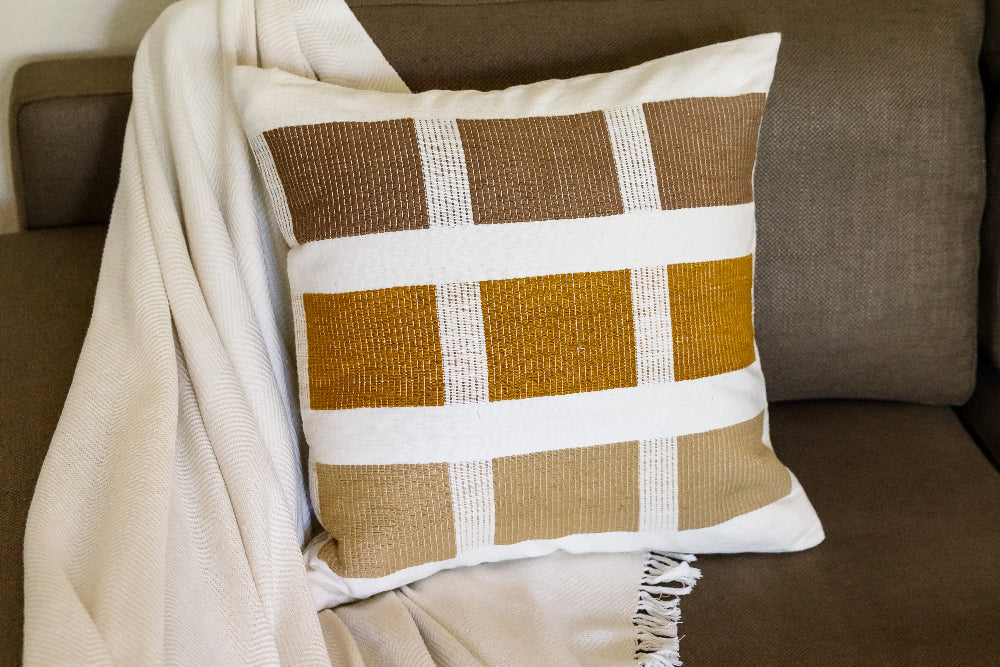 Kare pillow in bronze on brown couch