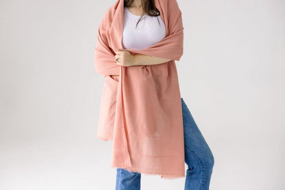 Maraki shawl in blush on the front of a female model