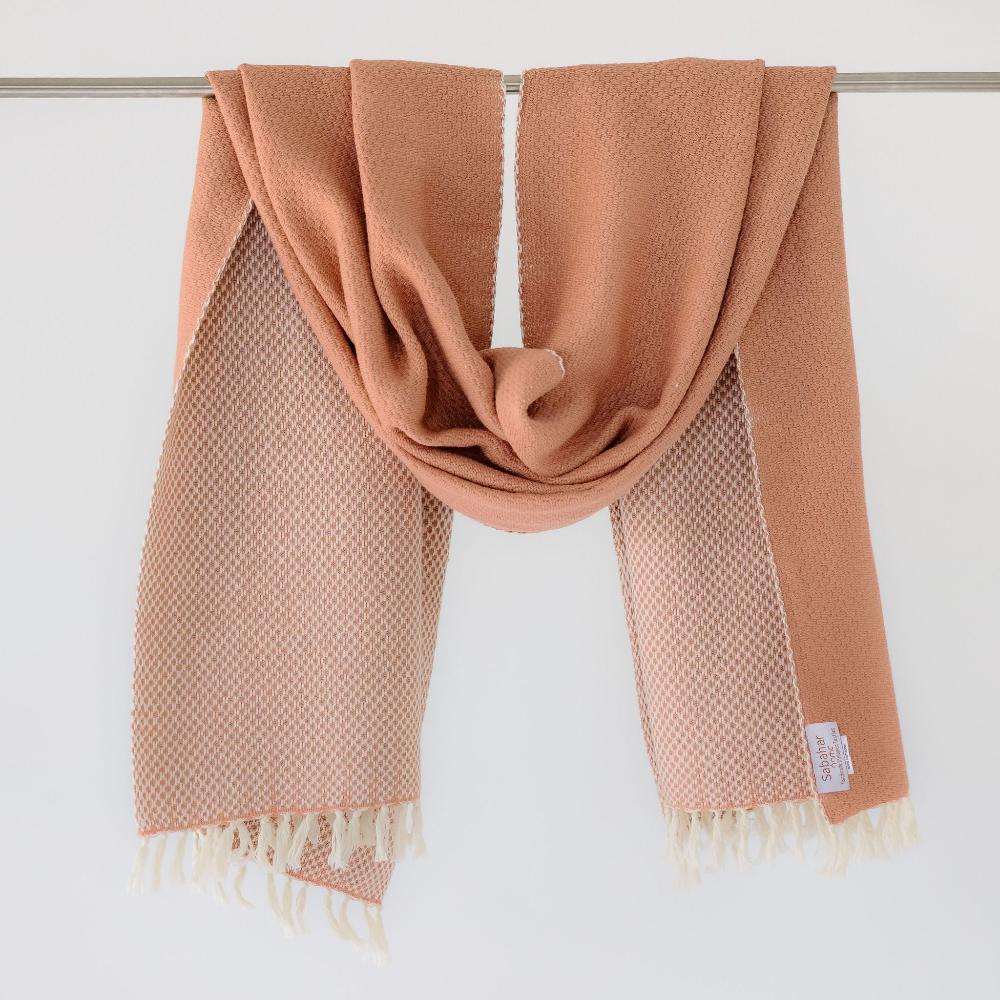 Maya shawl in blush hanging on bar