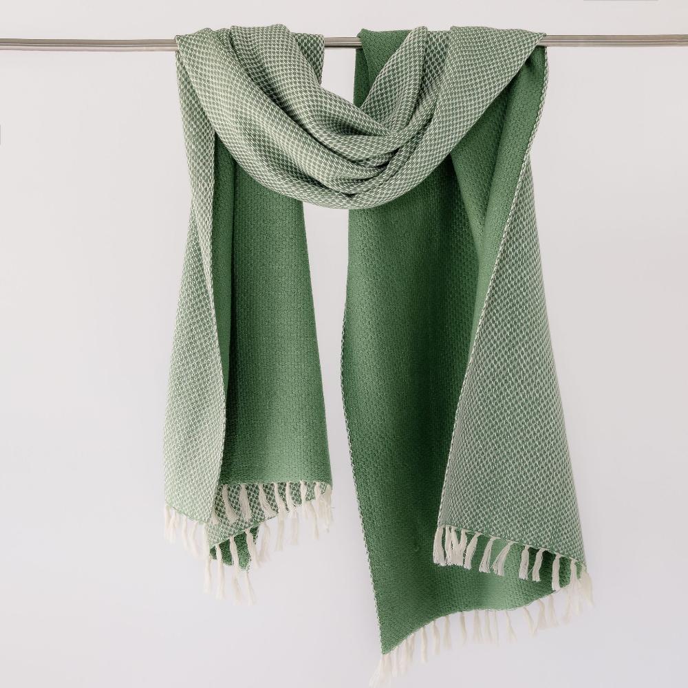 Mint Maya shawl hanging on a bar