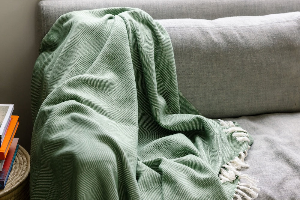 Mechot throw blanket in mint on couch