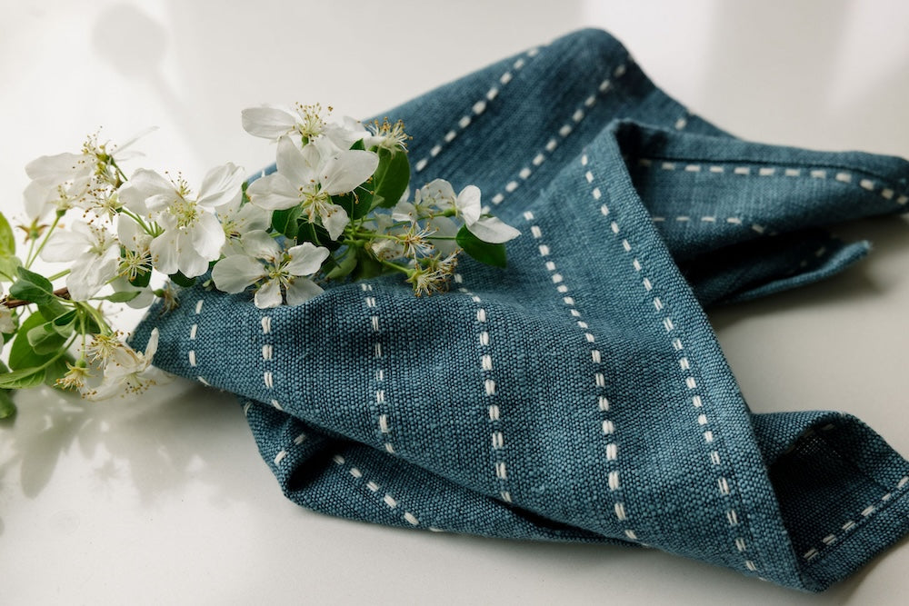 Rift Valley cocktail napkin in navy with a flower