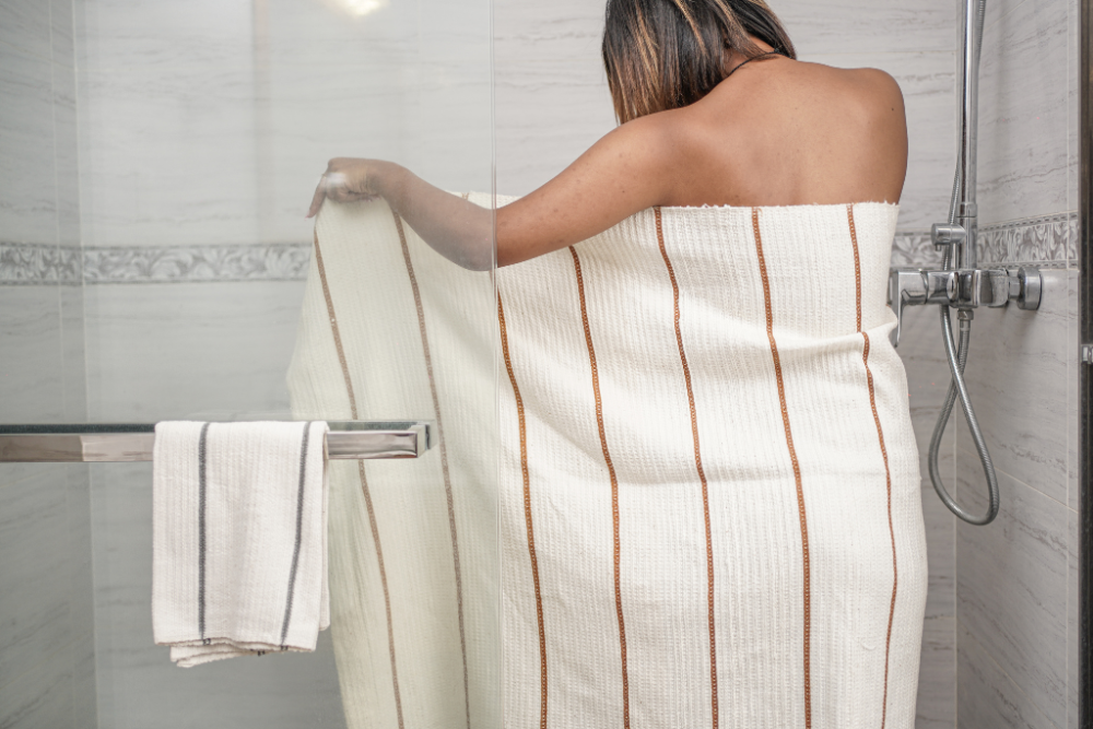 Person wrapped in wari towel in a bathroom
