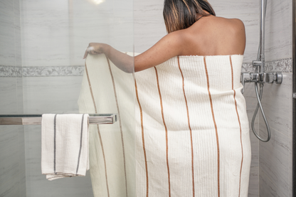 Person wrapped in wari towel in a bathroom