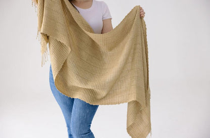 Queen Saba pure silk shawl being shown off on a female model with white background. 