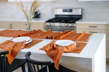 Rift Valley table runner, placemat and cocktail napkins with Semien placemats in copper in kitchen 