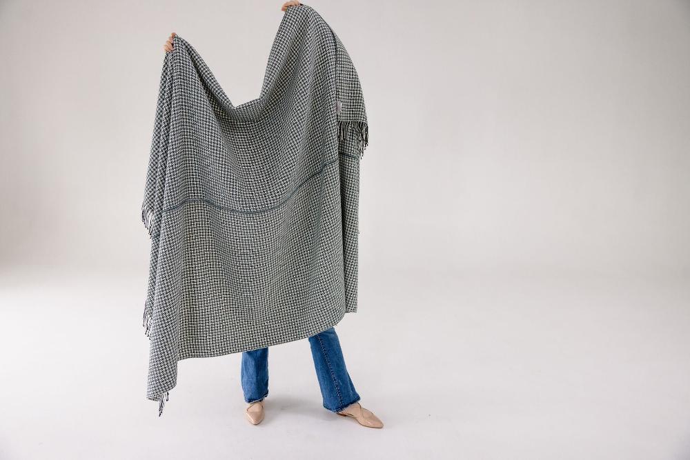 Sitota throw blanket held by a model on white background