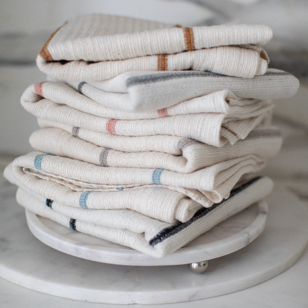Stack of folded wari towels on a marble surface