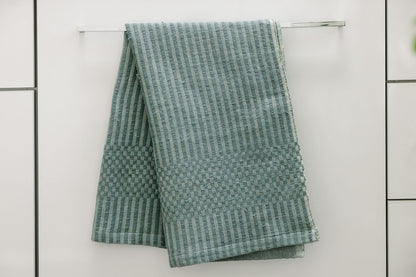 Tana hand towel in clay hanging in bathroom