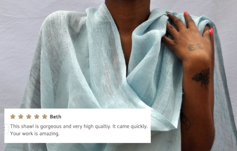 Telba linen shawl in azurro on a model. 