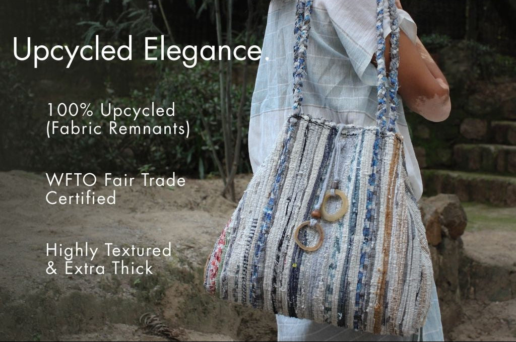 Upcycled handbag held by a person with text about upcycling and fair trade certification.