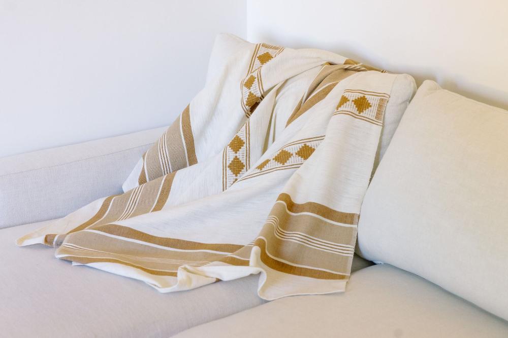 Weyra Towel in beige and bronze on couch